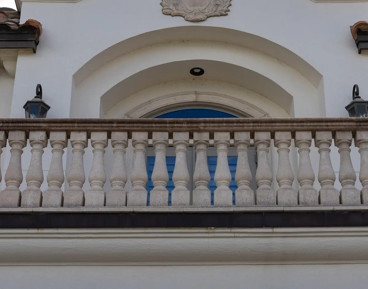 Entry arch and balustrade before, muted grey with years of buildup