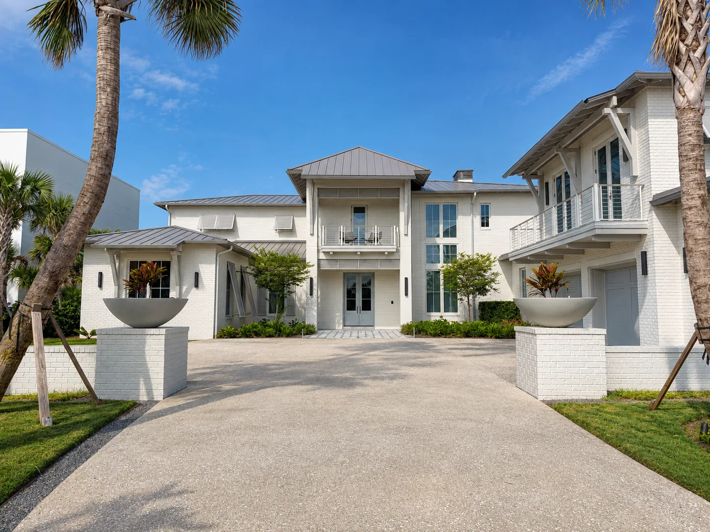 A white coastal estate seen from the drive