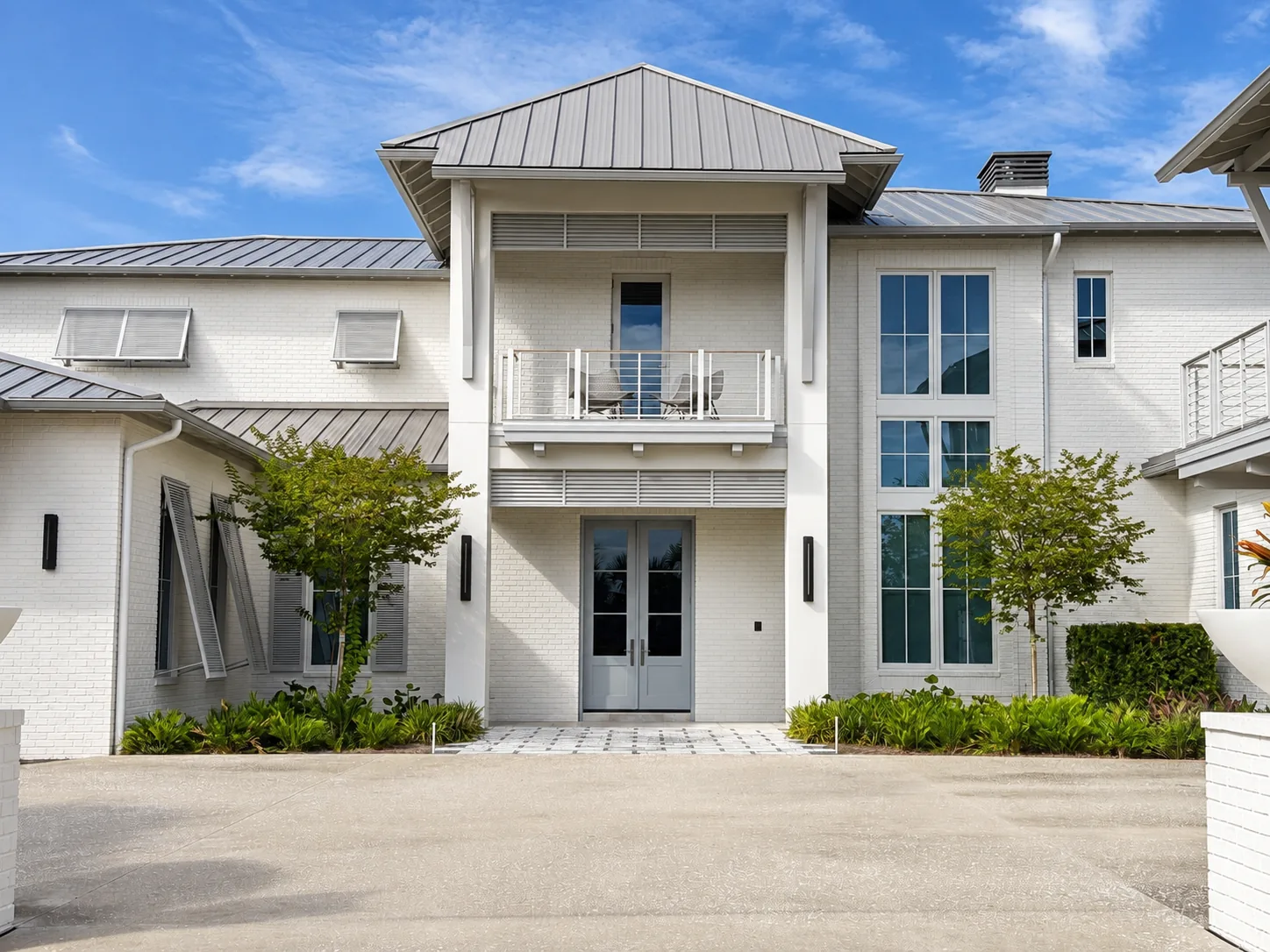 The front entry and balcony under a standing seam roof